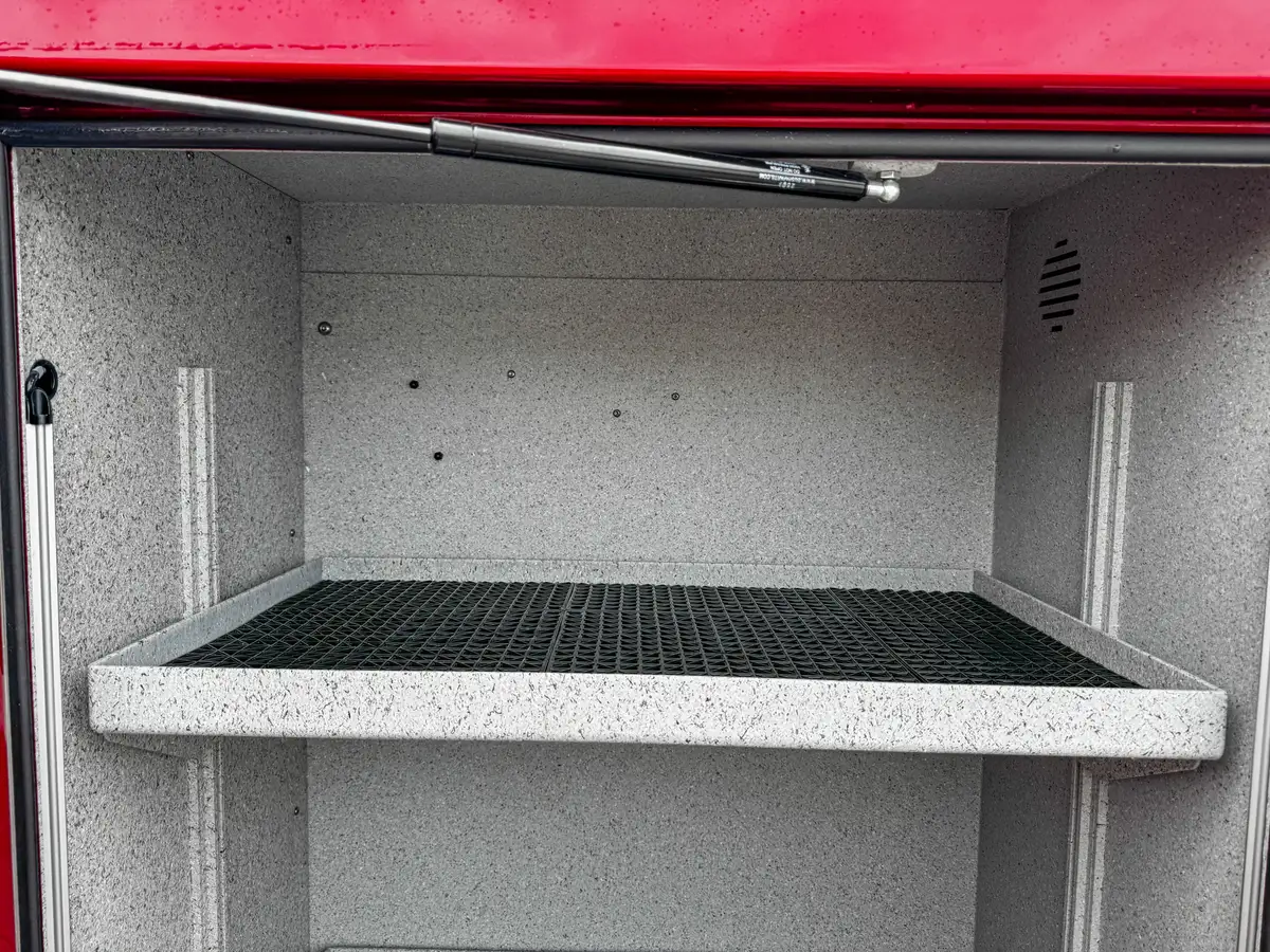 Lower tray extended from compartment showing non-slip pull-out surface.